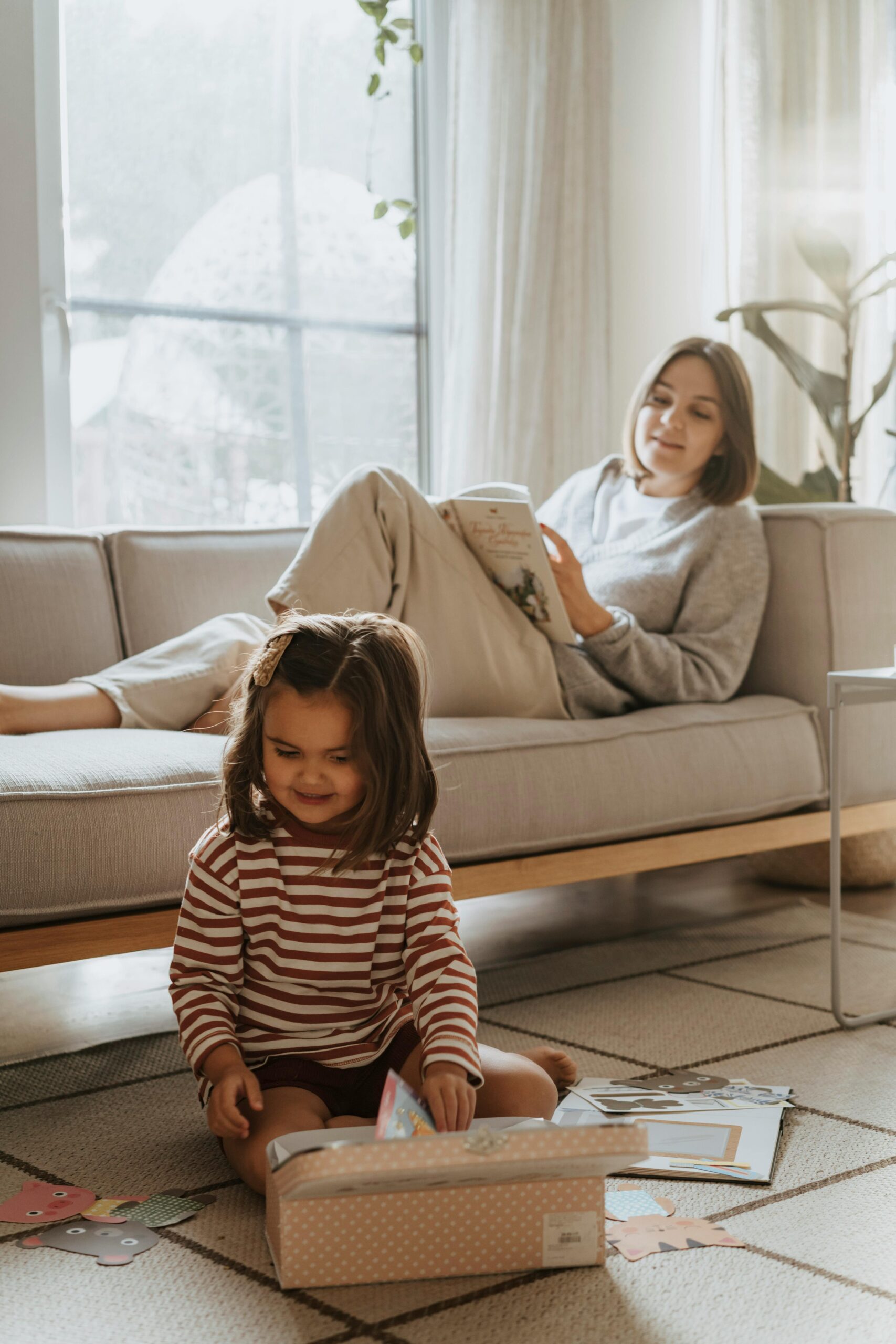 Mother and daughter enjoying leisure time indoors, embodying warmth and togetherness.